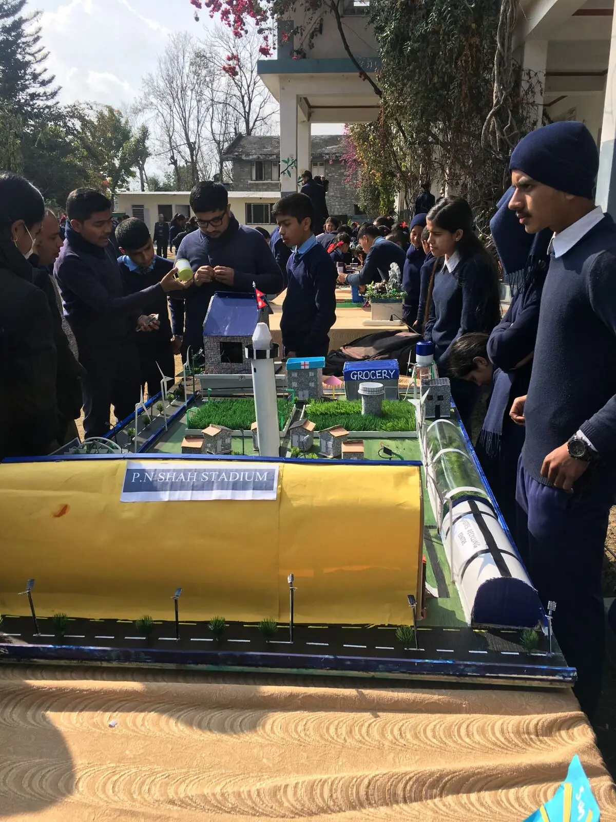 Students with a stadium model project